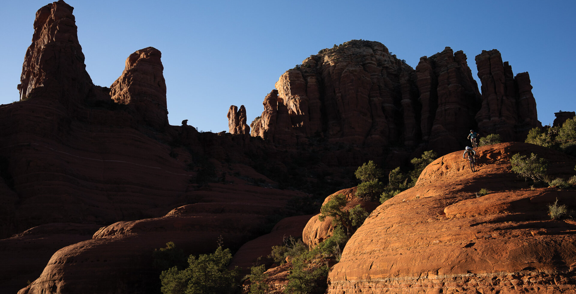 Amaryth “Amo” Gass and Evan Puglia, of the Sedona Mountain Bike Academy, find some steeps off Chicken Point in Sedona. Perhaps nowhere in Arizona has folded mountain biking into its identify so successfully as Sedona. Photo: Anne Keller | SONY 1/500, f/7.1, ISO 320