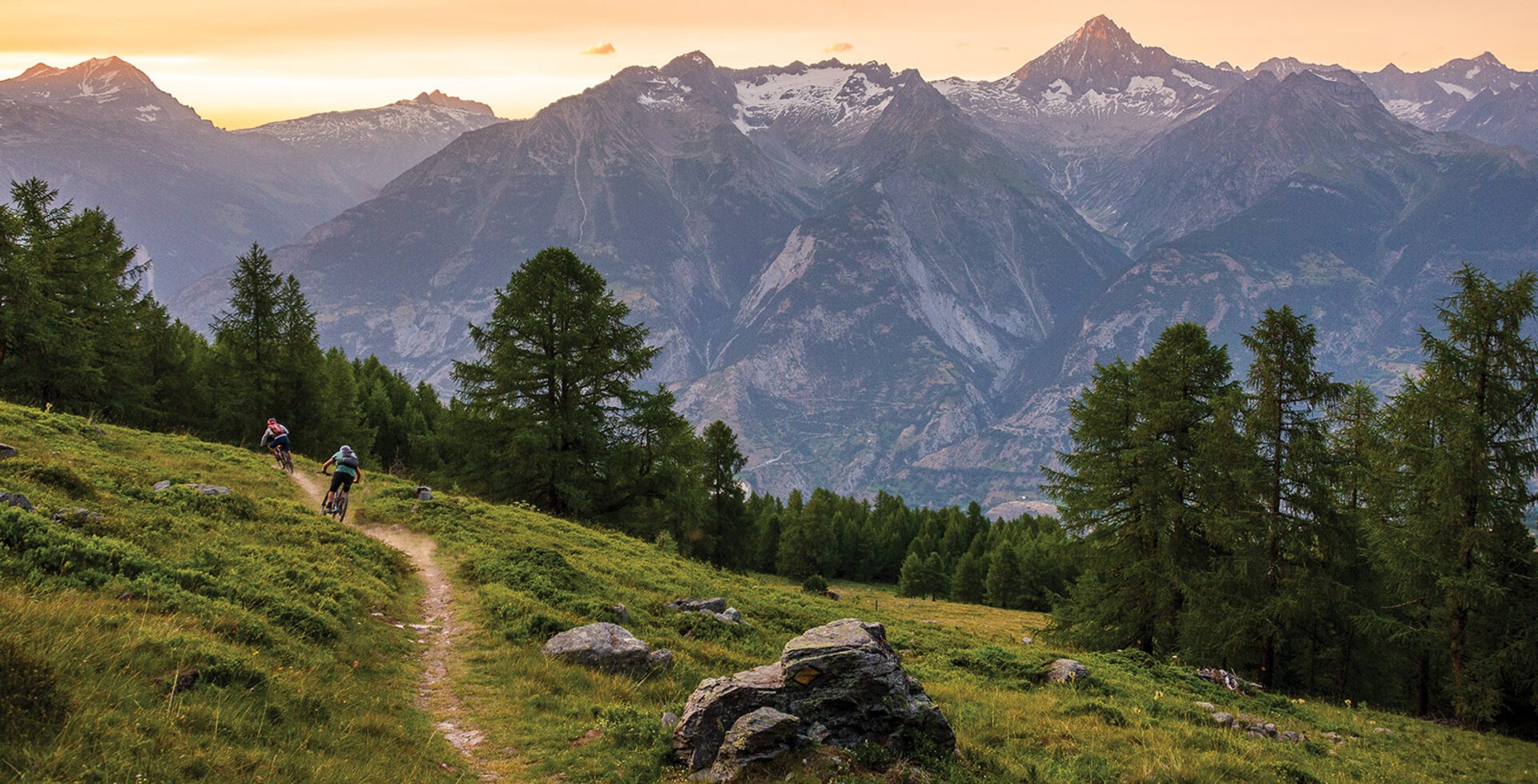 Writer Andrew Findlay and Christian Ammann, the visionary behind Bike Saumer guide company, flow along a trail overlooking Bürchen, Switzerland. The narrow, smooth path emerged organically over generations of foot and hoof traffic to form part of what is now a sprawling recreational trail network that connects towns and villages across the Alps.