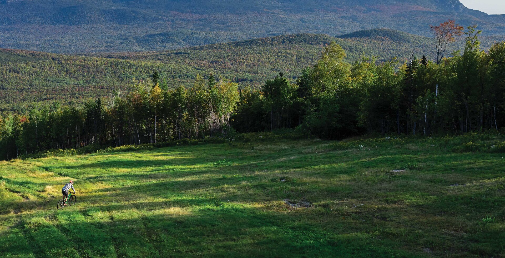 Peter Cole drops into the West Knoll trail just after sunrise, with Bigelow Mountain serving as an impressive backdrop over the north side of Carrabassett Valley. 57