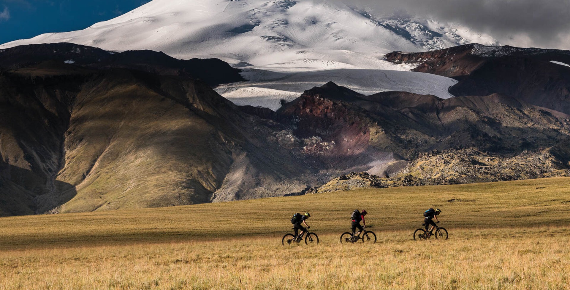 The grassy Bechassyn Plateau affords mesmerizing views of Mount Elbrus’ majestic north face. Fred Horny, Dennis Beare and the author make hay while the sun shines.