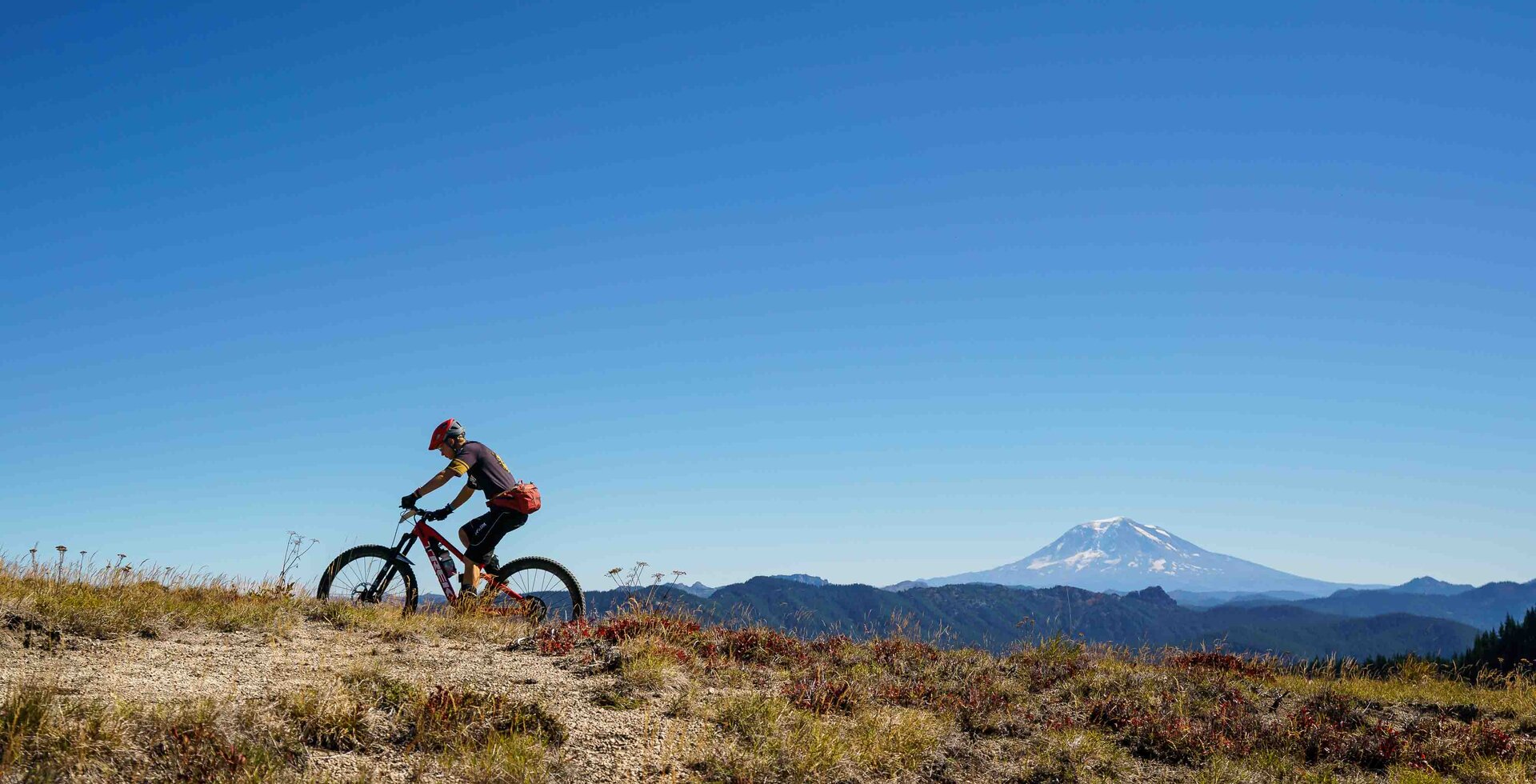 There’s no shortage of views throughout Trans-Cascadia’s race weekend, but perfectly blue skies are considered a luxury. Taking place in late September, weather is always a gamble but perfect dirt is all but guaranteed, and that’s a worthwhile trade off. A racer makes the journey to stage six on day two, with Mt. Adams dominating the horizon. Photo: Joshua Lawton