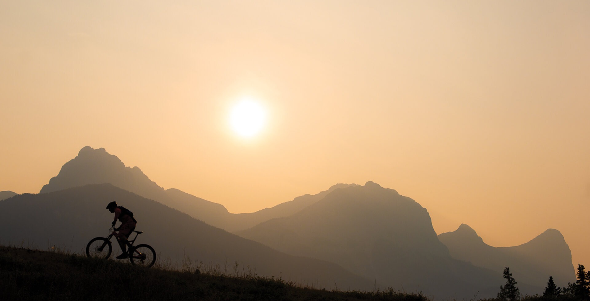 Dave Kinn rides through forest fire smoke in Canmore, Alberta. Canada’s climate is warming at a more rapid rate than most other places in the world. Photo: John Gibson