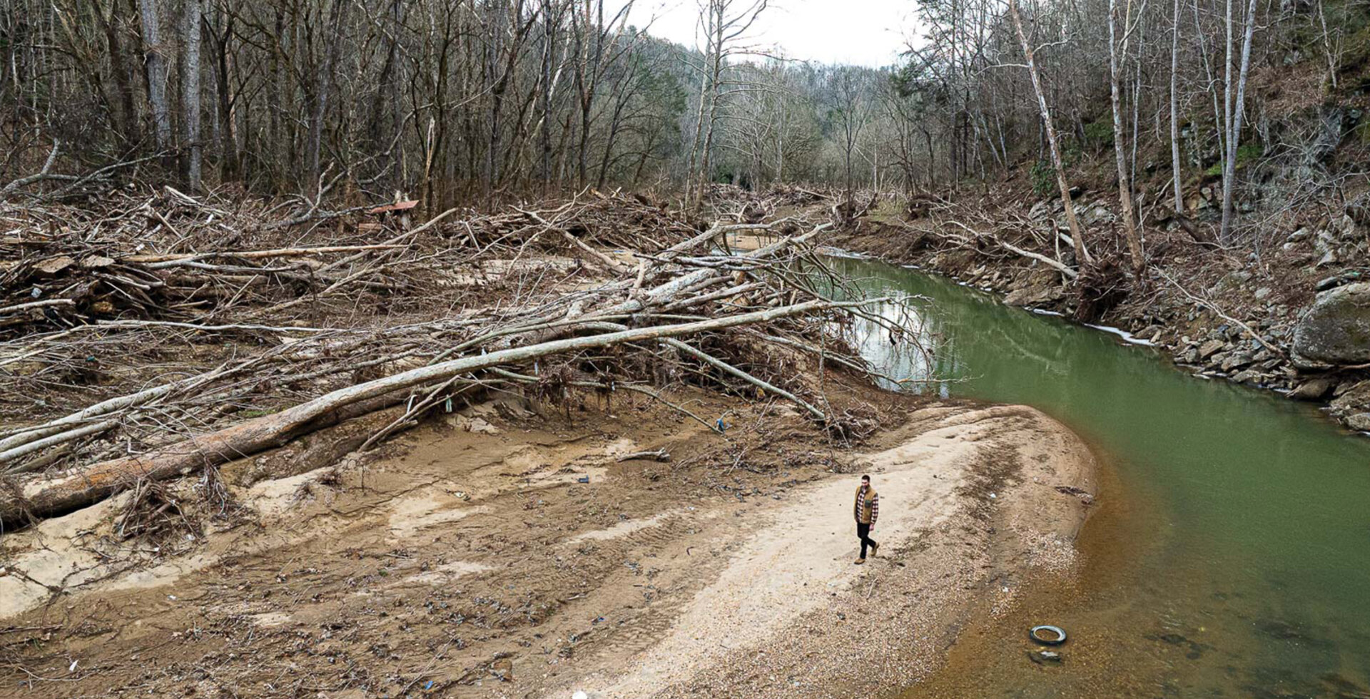 Peter Mills walks along Ivy Creek in late January, four months after Hurricane Helene tore through North Carolina and caused billions of dollars of damage.