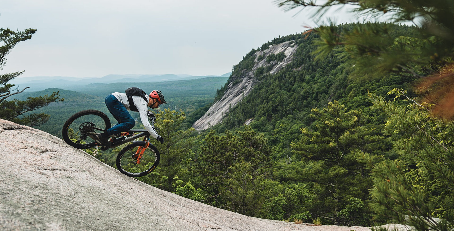 Peter Ostroski rides the granite wave in North Conway, New Hampshire. As granite erodes through cold temperatures in winter and summer heat, it sheds layers like an onion.