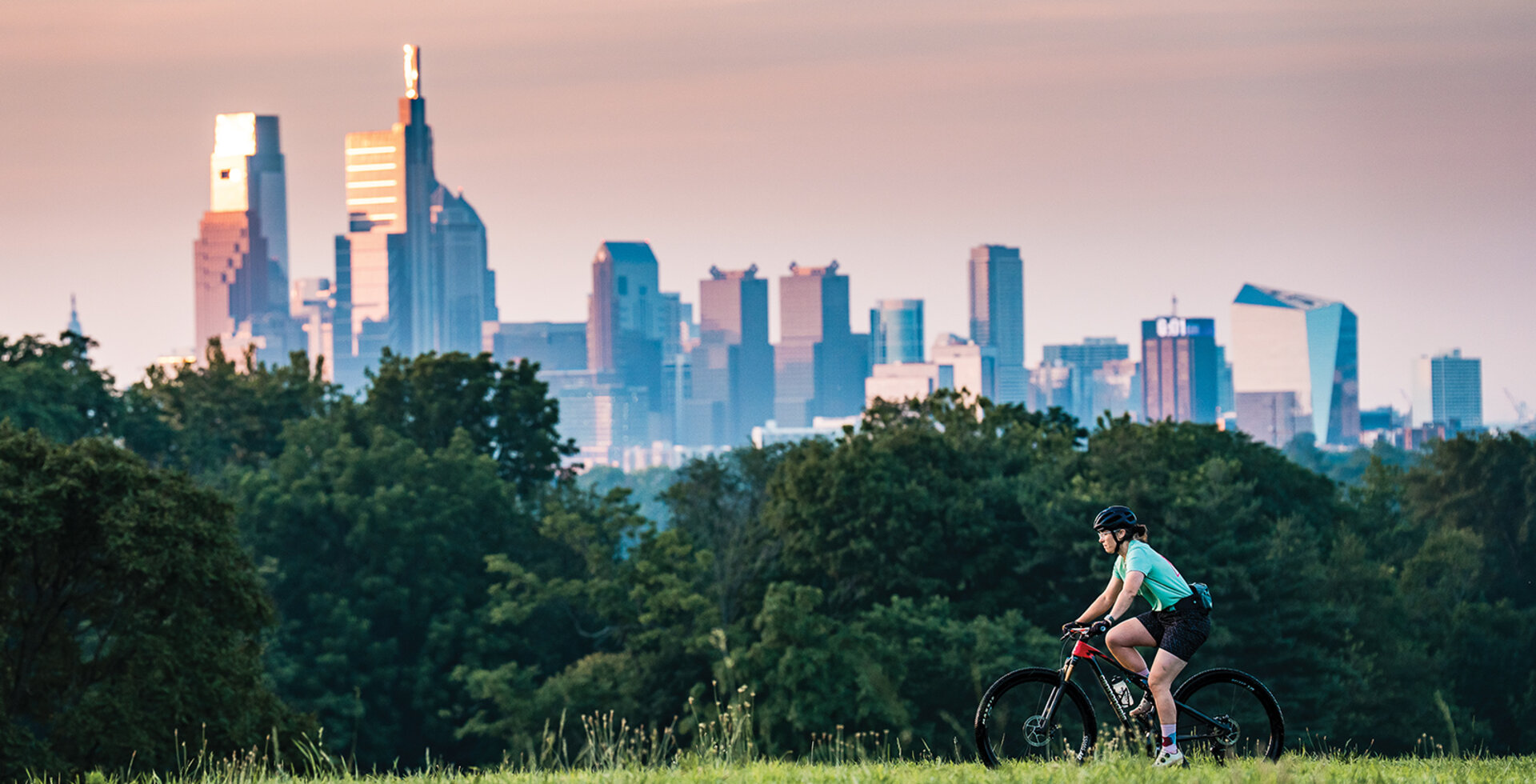 Kelly Roberson cruises over the Belmont Plateau on a dawn patrol ride in July. Early mornings are key for Philadelphia mountain bikers looking to beat the heat.