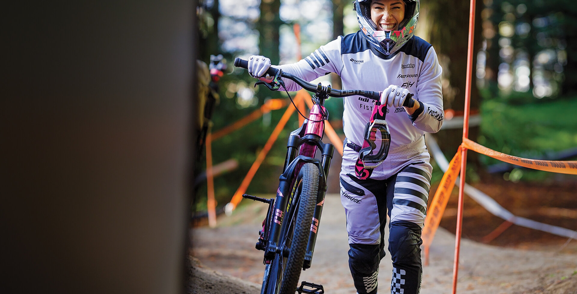 Caroline Buchanan walks her bike up for another run at the 2024 edition of Crankworx Rotorua in New Zealand. Buchanan credits the Crankworx series for rewarding mountain bikers who focus on more than one discipline.