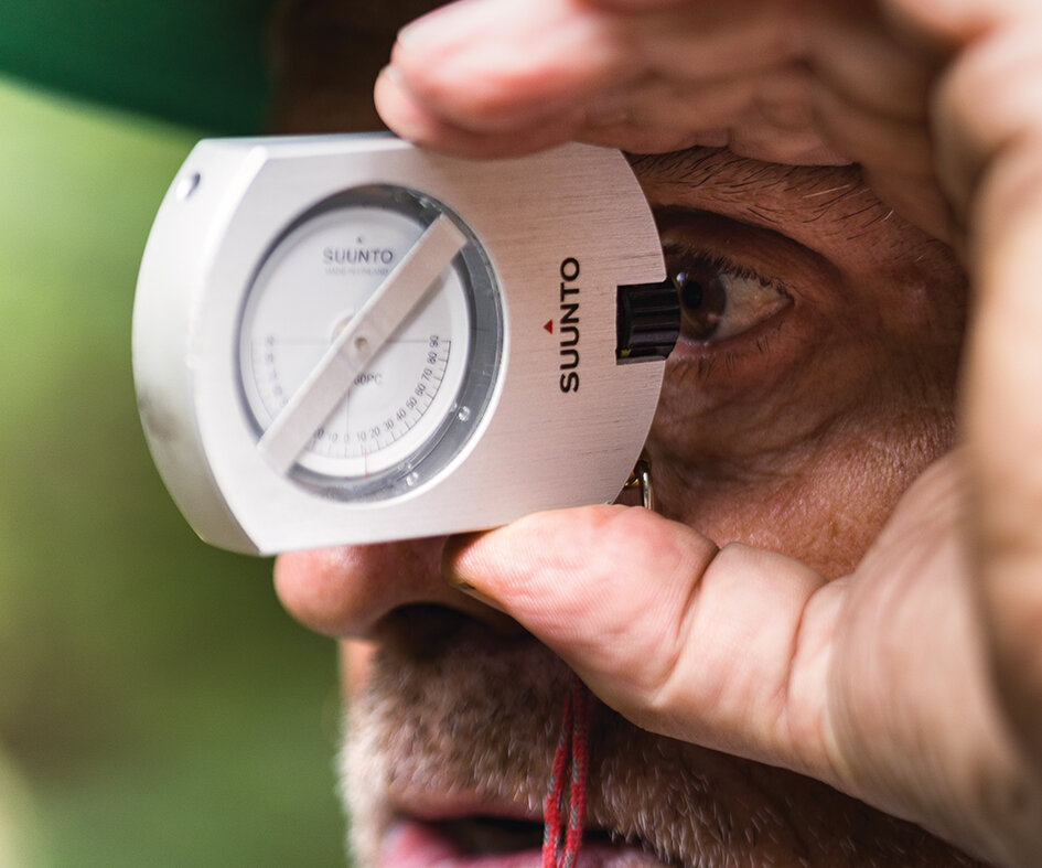 Gravity Logic co-founder Tom “Pro” Prochazka uses a clinometer to measure the grade of a slope during a build in British Columbia. Prochazka worked as the manager of the Whistler Bike Park from 2001 to 2007. Photo: Robin O’Neill