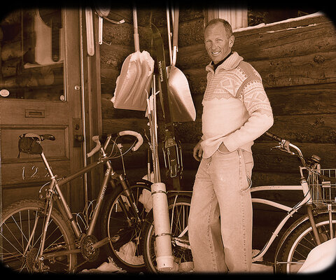 Don Cook poses on the front porch of his log cabin home in Crested Butte, Colorado. Taken by photographer J.C. Leacock, the portrait was part of an athletes of Crested Butte series. Don is pictured with his trusty winter town bike that he’d ridden since 1980, along with his custom, drop-bar Moots.