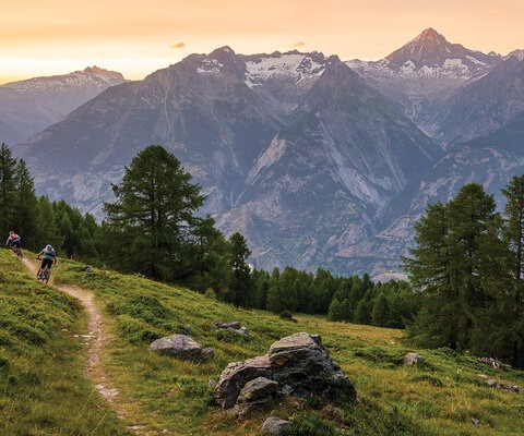 Writer Andrew Findlay and Christian Ammann, the visionary behind Bike Saumer guide company, flow along a trail overlooking Bürchen, Switzerland. The narrow, smooth path emerged organically over generations of foot and hoof traffic to form part of what is now a sprawling recreational trail network that connects towns and villages across the Alps.