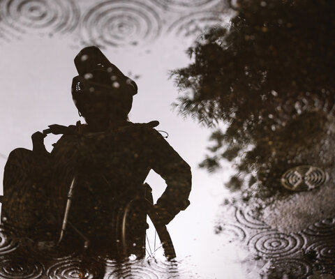 Rider Annijke Wade is reflected in puddles of rainwater while gearing up to ride trails at Grouse Mountain near Vancouver. British Columbia has made recent strides toward becoming one of the most adaptive-friendly mountain bike locations in the world.