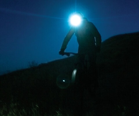 So many of the best adventures begin and end in the dark. Writer Dillon Osleger pedals through a sea of blackness on his way to descending the elevational equivalent of the lowest point of the Mariana Trench in one single day of riding.