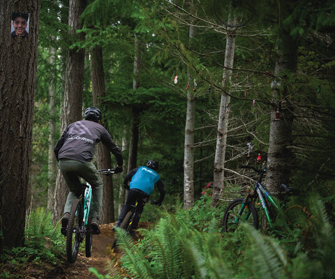 Grant (left) and Linc Laird launch into the Mattmo trail in Nanaimo. A picture of Matthew “Mattmo” Jeromkin hangs from a tree in honor of the young rider who passed away in early 2022. Photo: Dave Silver