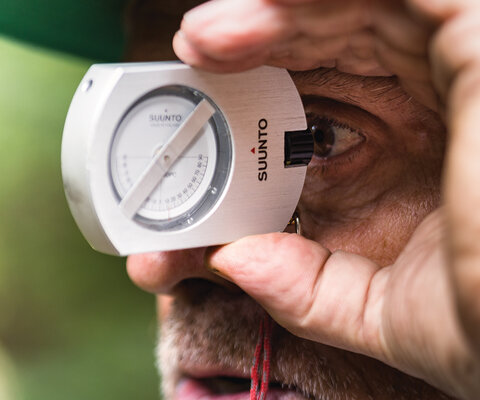 Gravity Logic co-founder Tom “Pro” Prochazka uses a clinometer to measure the grade of a slope during a build in British Columbia. Prochazka worked as the manager of the Whistler Bike Park from 2001 to 2007. Photo: Robin O’Neill