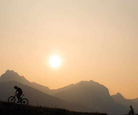 Dave Kinn rides through forest fire smoke in Canmore, Alberta. Canada’s climate is warming at a more rapid rate than most other places in the world. Photo: John Gibson