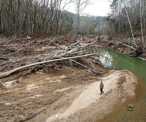 Peter Mills walks along Ivy Creek in late January, four months after Hurricane Helene tore through North Carolina and caused billions of dollars of damage.