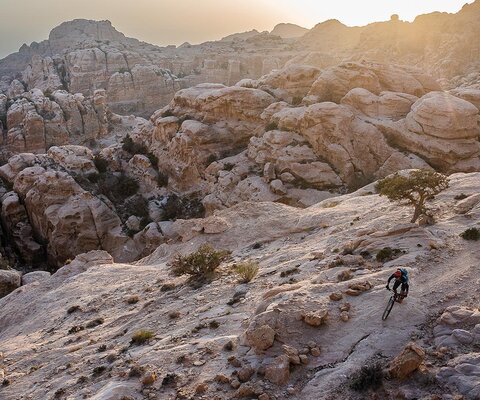 Andrew Findlay leads Sari Husseini through a rocky section of the Jordan Trail in the Shobak Qasabah District of Jordan.