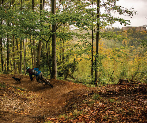 Iwona Kurczab carves through a berm on a trail that parallels the ruins of 18th-century Srebrna Góra Fortress Trasy at the Enduro Tracks Srebrna Góra riding area. The fortress was ordered built by King Frederick II, the Great of Prussia, and is one of the largest remaining mountain castles in Europe.  