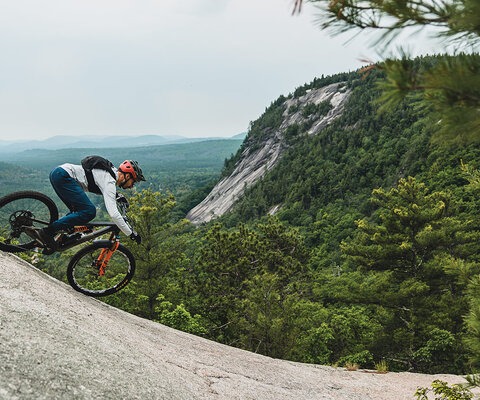 Peter Ostroski rides the granite wave in North Conway, New Hampshire. As granite erodes through cold temperatures in winter and summer heat, it sheds layers like an onion.