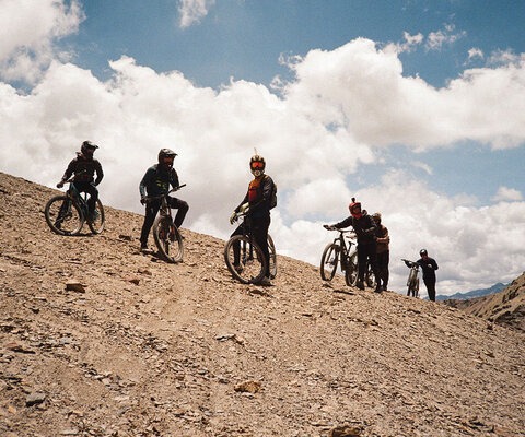 Riders (from left) Matt Russell, Knight Ide, Yannick Wende, Quinn Campbell, Myles Trainer, and Leif Trott hike to the top of their descent of the Milluni scree fields, nestled at the foot of Huayna Potosí in Bolivia. At an elevation of 18,000 feet, the climb was a grueling endeavor, yet the day and its unforgettable riding emerged as a highlight for the group. Photo: Hannah Bergemann