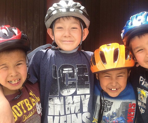 Young members of Boothroyd, BC’s Aboriginal Youth Mountain Bike Program smile with pride, ready to start work on the community’s new skills park. By the end of the weekend, their park would boast wood features, a pump track and gap jump—the kind of place worth being stoked about. Photo: Patrick Lucas